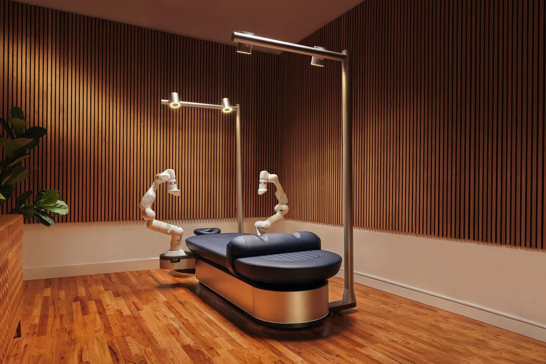 The ARC Recovery robotic massage machine, a padded table with two robotic arms