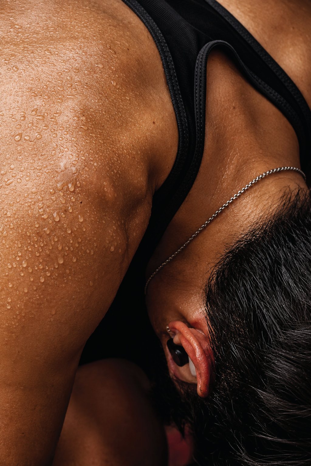 An athlete after training, hand on the back of the neck.